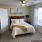 bedroom with a large window and modern decor