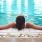 lifestyle image of a woman at a pool